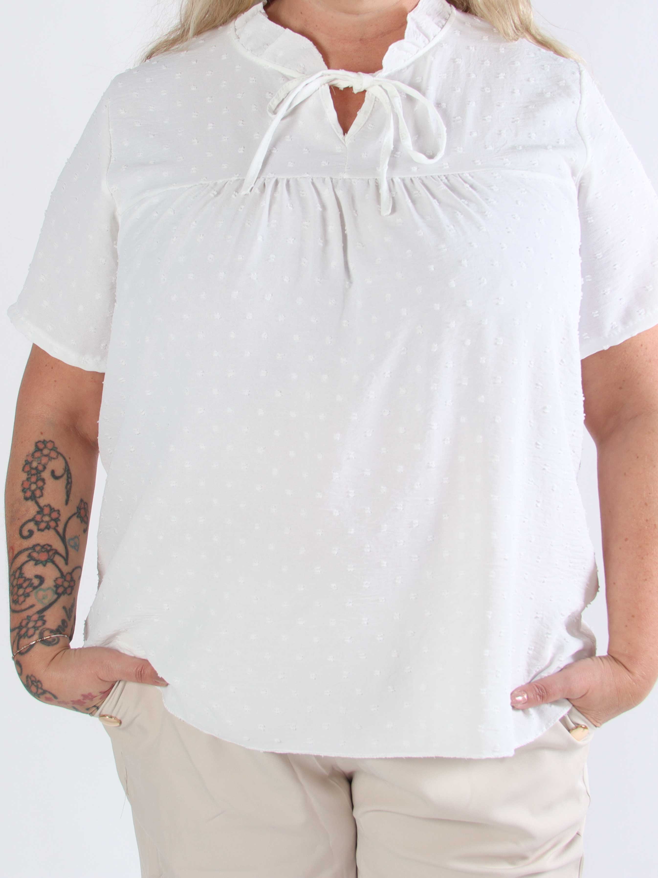 Bloom - Söt tunika i plusstorlek med volangkant och rosett